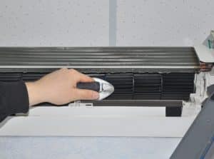 homeowner cleaning a ductless mini split