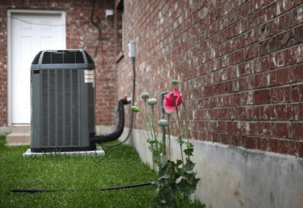 air conditioner in the backyard of a residential home