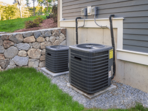 two air conditioners in the backyard of a residential home