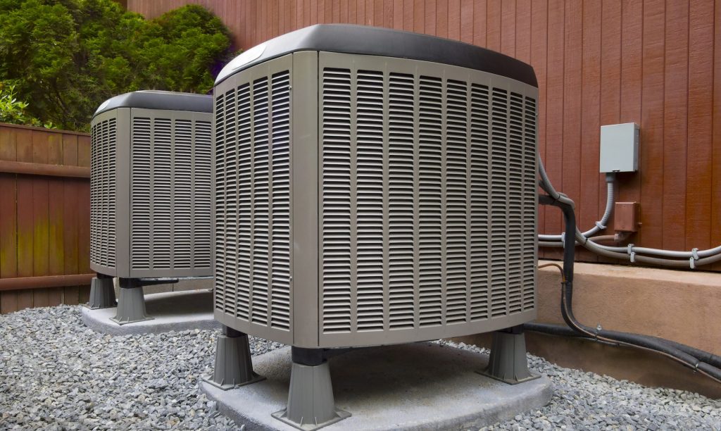 two air conditioning units outside a house