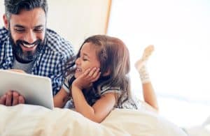 Improve your indoor air quality from allergens, dust, mold and breathe easier. Happy dad and daughter on laptop.