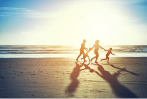 family running along san diego beach